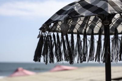 Close-up of snow on beach against sky