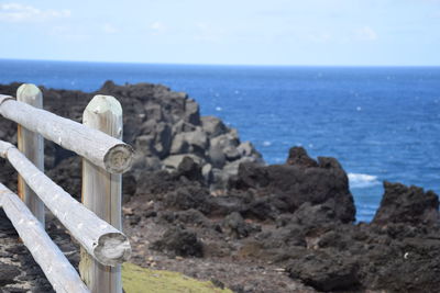 Scenic view of rocks on beach against sky