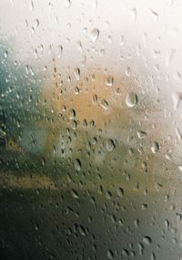 Full frame shot of raindrops on glass window