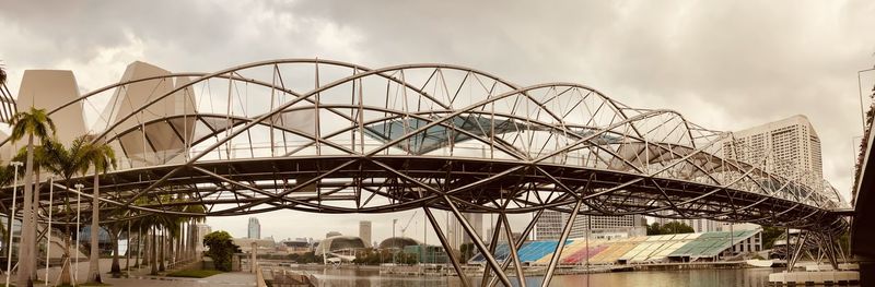 Low angle view of bridge against sky in city