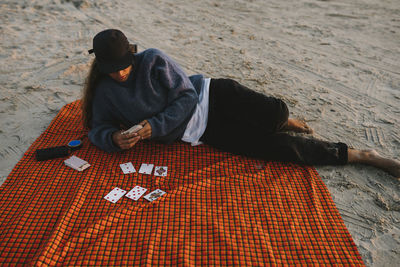 Woman playing cards on beach