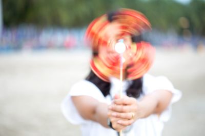 Woman holding spinning pinwheel toy 