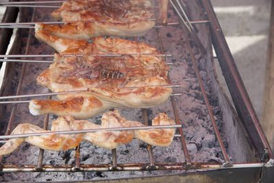 High angle view of meat on barbecue grill