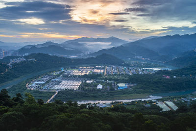 High angle view of buildings and mountains against sky