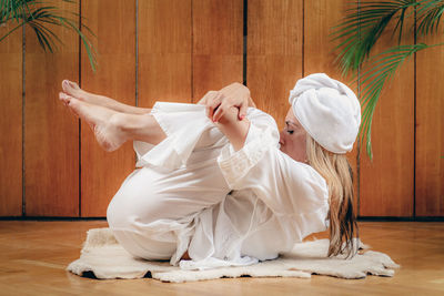 Woman practicing kundalini yoga, kriya exercises for the navel center and bowel waste elimination