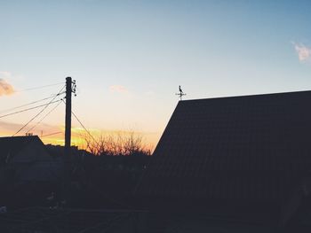 Low angle view of silhouette building against sky