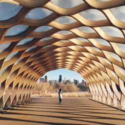 Full length of woman walking in tunnel