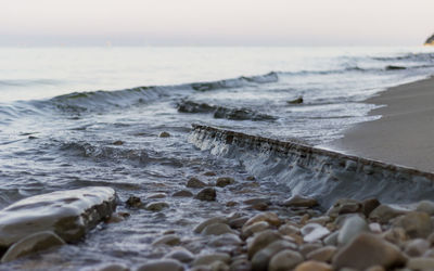 Close-up of waves in sea against sky