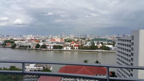 High angle view of city against cloudy sky