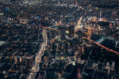 High angle view of city lit up at night