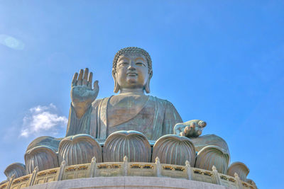 Low angle view of statue against blue sky