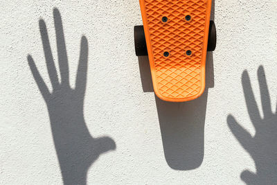 Shadow of skateboard and shadow on footpath