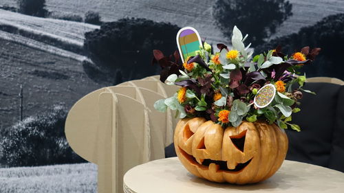 Close-up of flower pot on table. halloween. pumpkin.