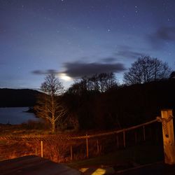 Scenic view of landscape against sky at night