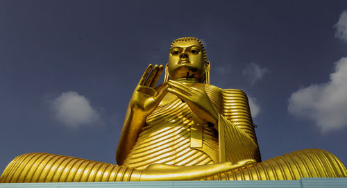 Low angle view of statue against sky