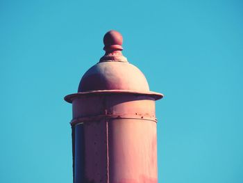 Low angle view of storage tank against clear blue sky