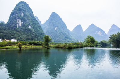 Scenic view of lake and mountains against clear sky