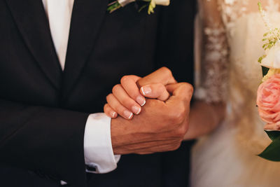 Close-up of couple holding hands