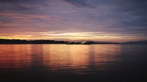 Tranquil view of river at sunset