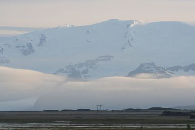 Scenic view of snow covered mountains against sky