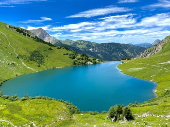 Scenic view of lake and mountains against sky