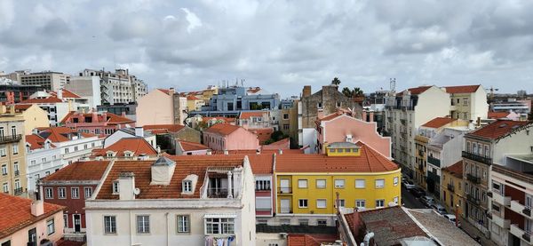 Buildings in town against sky