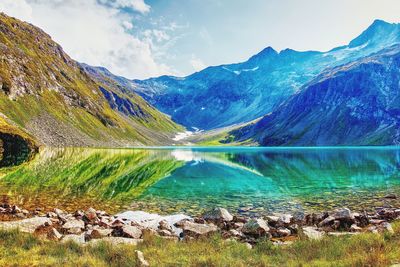 Scenic view of lake and mountains against sky