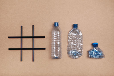 Hashtag recycling. empty plastic bottles, cup and bottle cap put in a row after hashtag