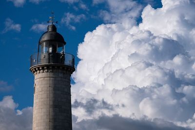 Low angle view of lighthouse against cloudy sky