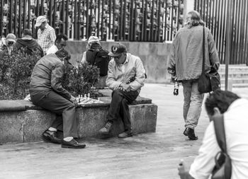 Men on sidewalk in city