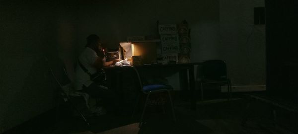 Side view of man working on table