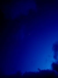 Low angle view of moon in sky at night