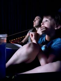 Side view of boy playing guitar