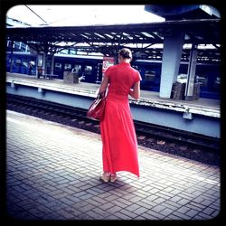 Woman sitting on railroad track