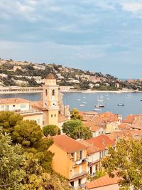 Townscape by sea against sky in city