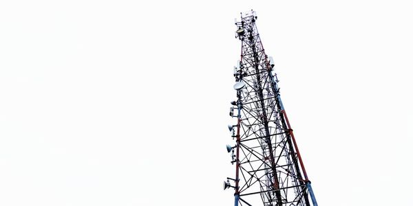 Low angle view of communications tower against clear sky