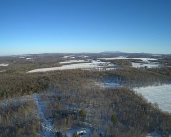 Scenic view of landscape against clear sky during winter