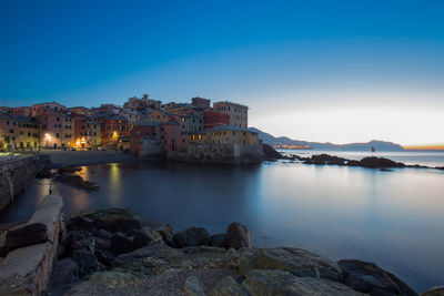 Town by sea against clear sky in city