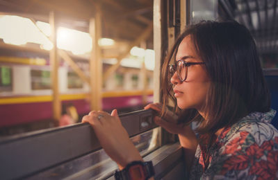 Portrait of young woman using mobile phone