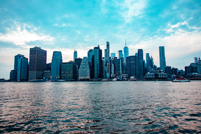 City at waterfront against sky