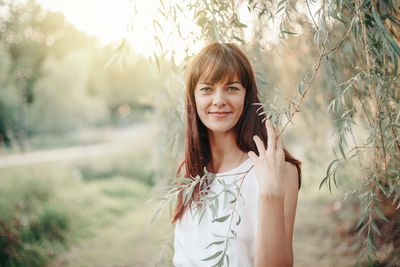 Portrait of smiling young woman standing outdoors