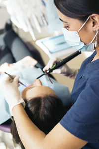 Dentist examining woman