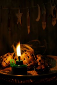 Close-up of lit candles on table