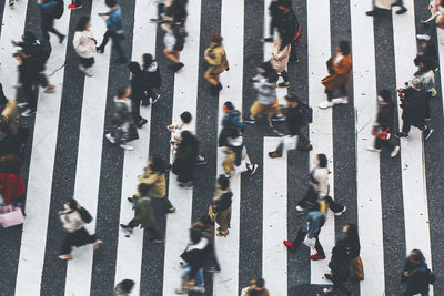 High angle view of people walking on wet road