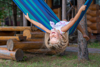 Smiling girl playing on hammock