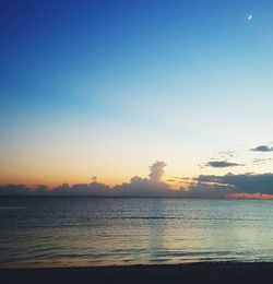 Scenic view of sea against clear sky at sunset