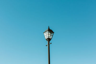 Low angle view of street light against clear blue sky