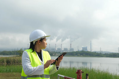 Side view of man working at lake