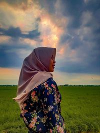 Farmer girl girl looks at her rice field