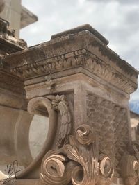 Low angle view of historical building against cloudy sky